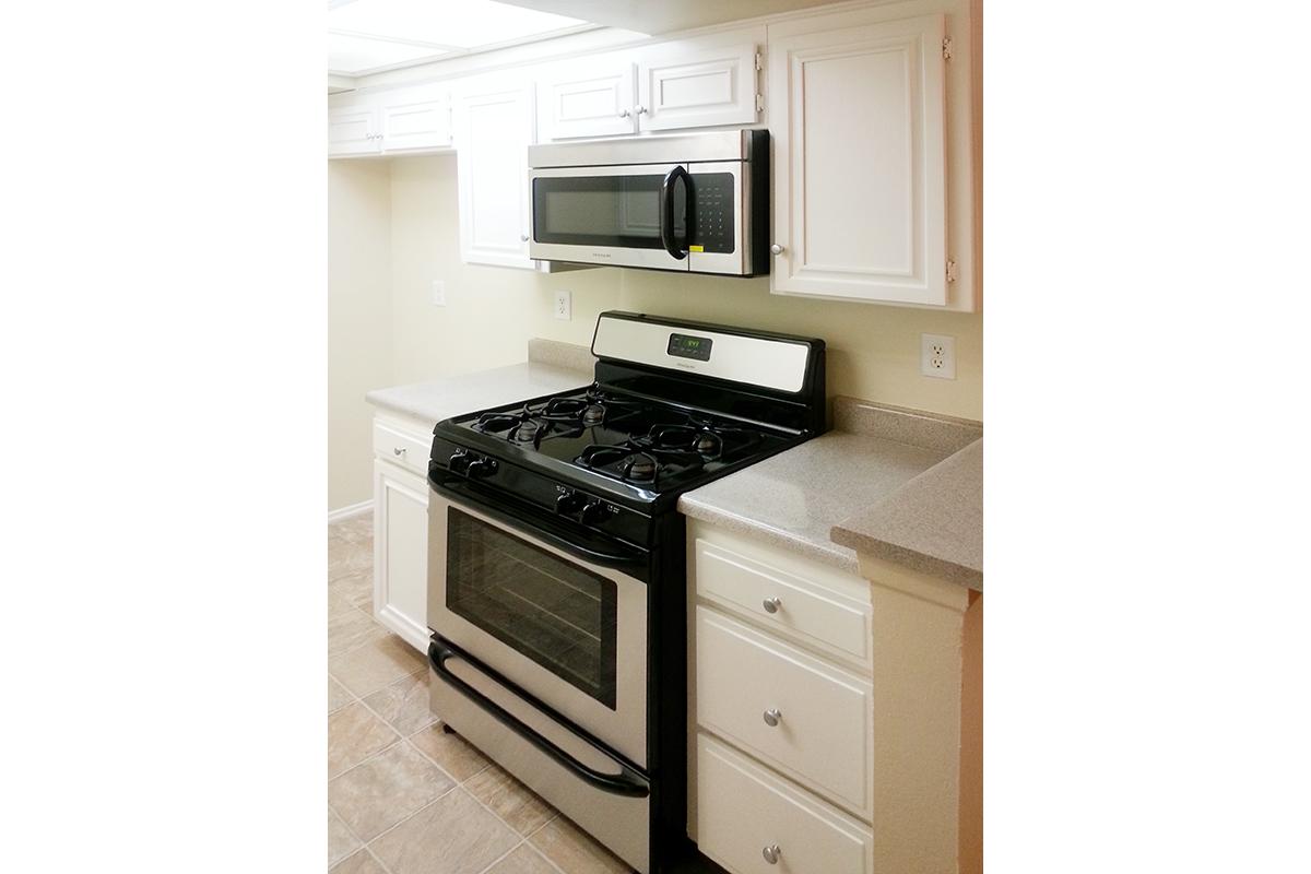 a stove top oven sitting inside of a kitchen