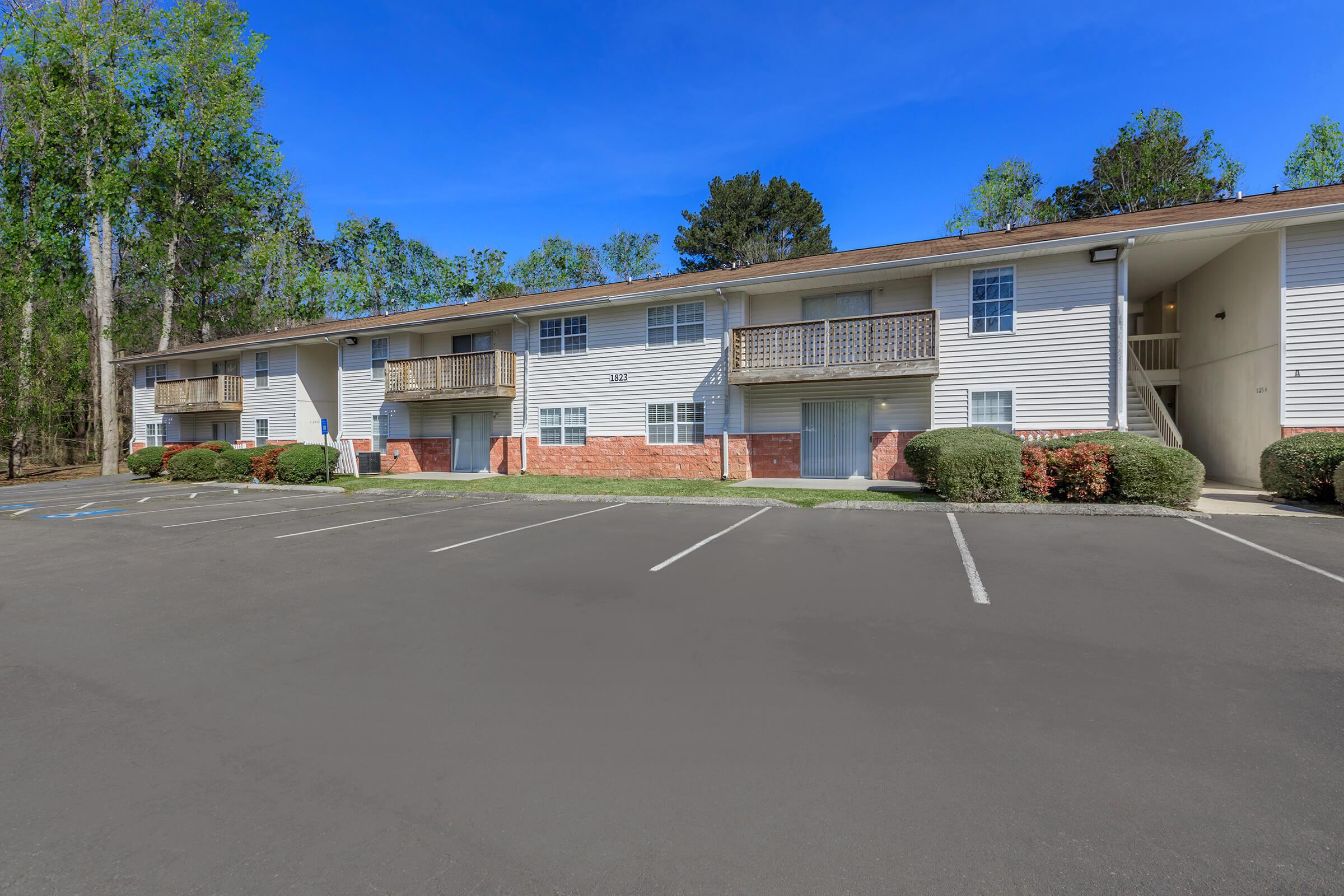 an empty parking lot in front of a house