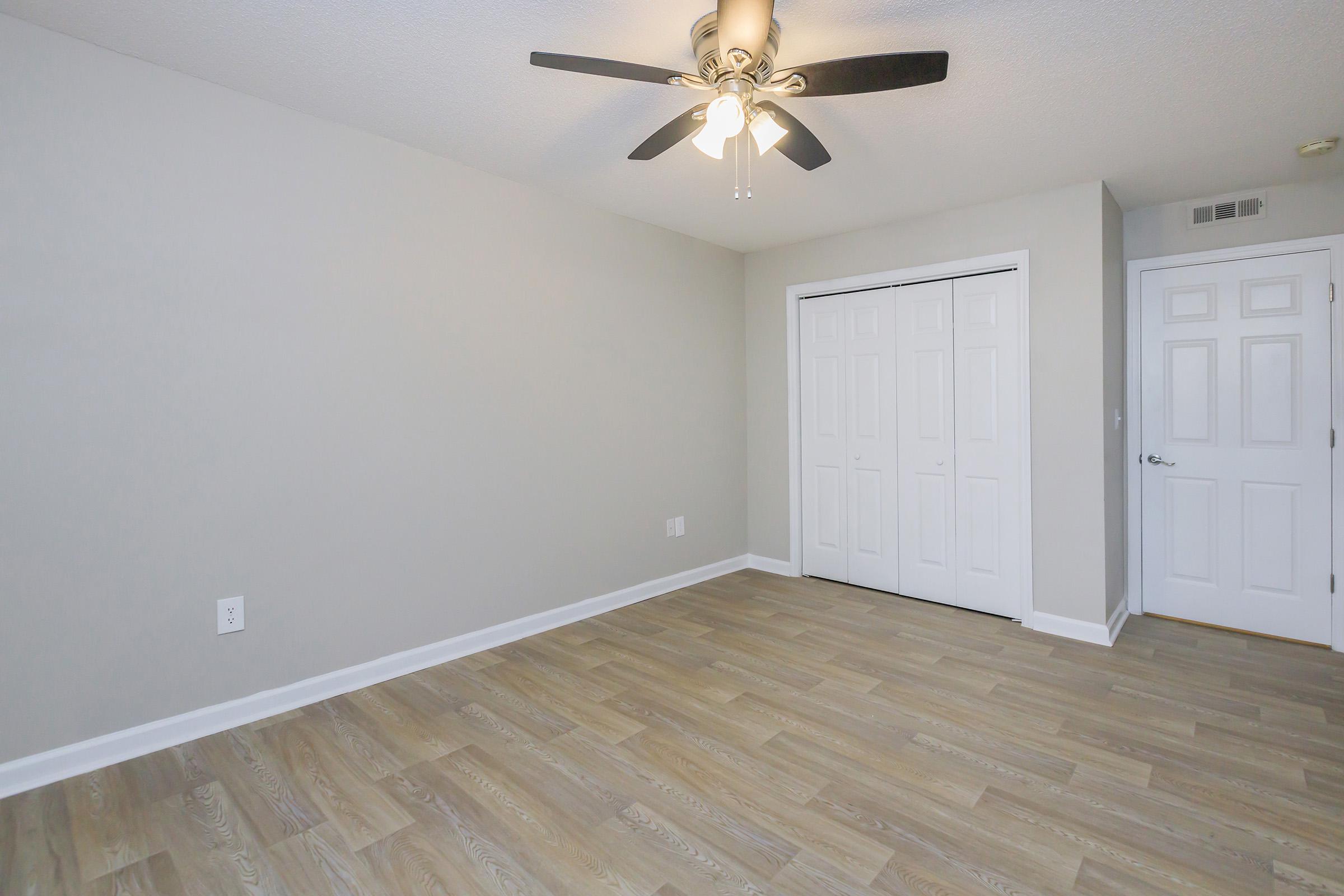 a large empty room with a wooden floor