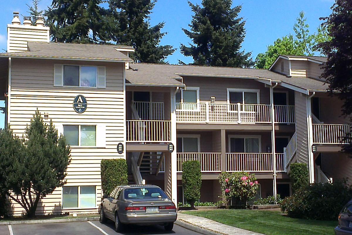 a house with bushes in front of a building