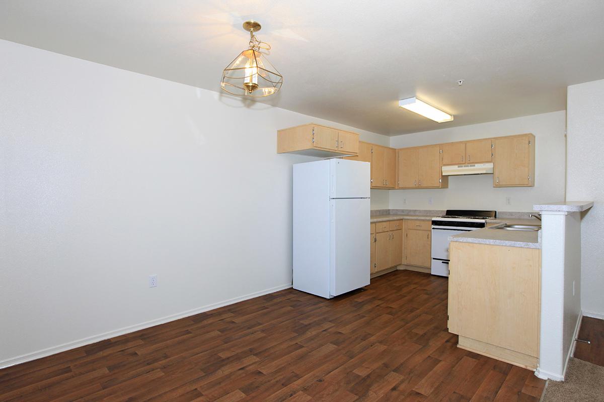 Dining room and kitchen with wooden floors