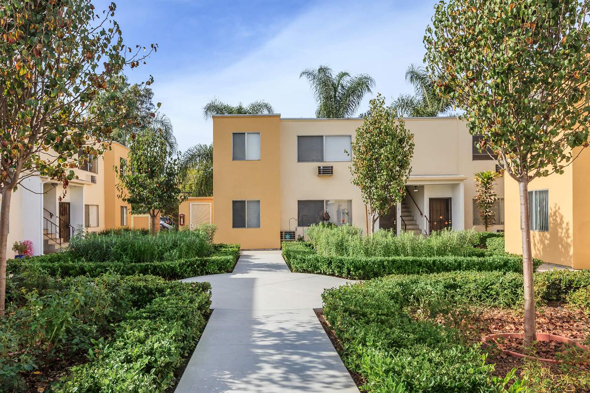 a house with bushes in front of a building