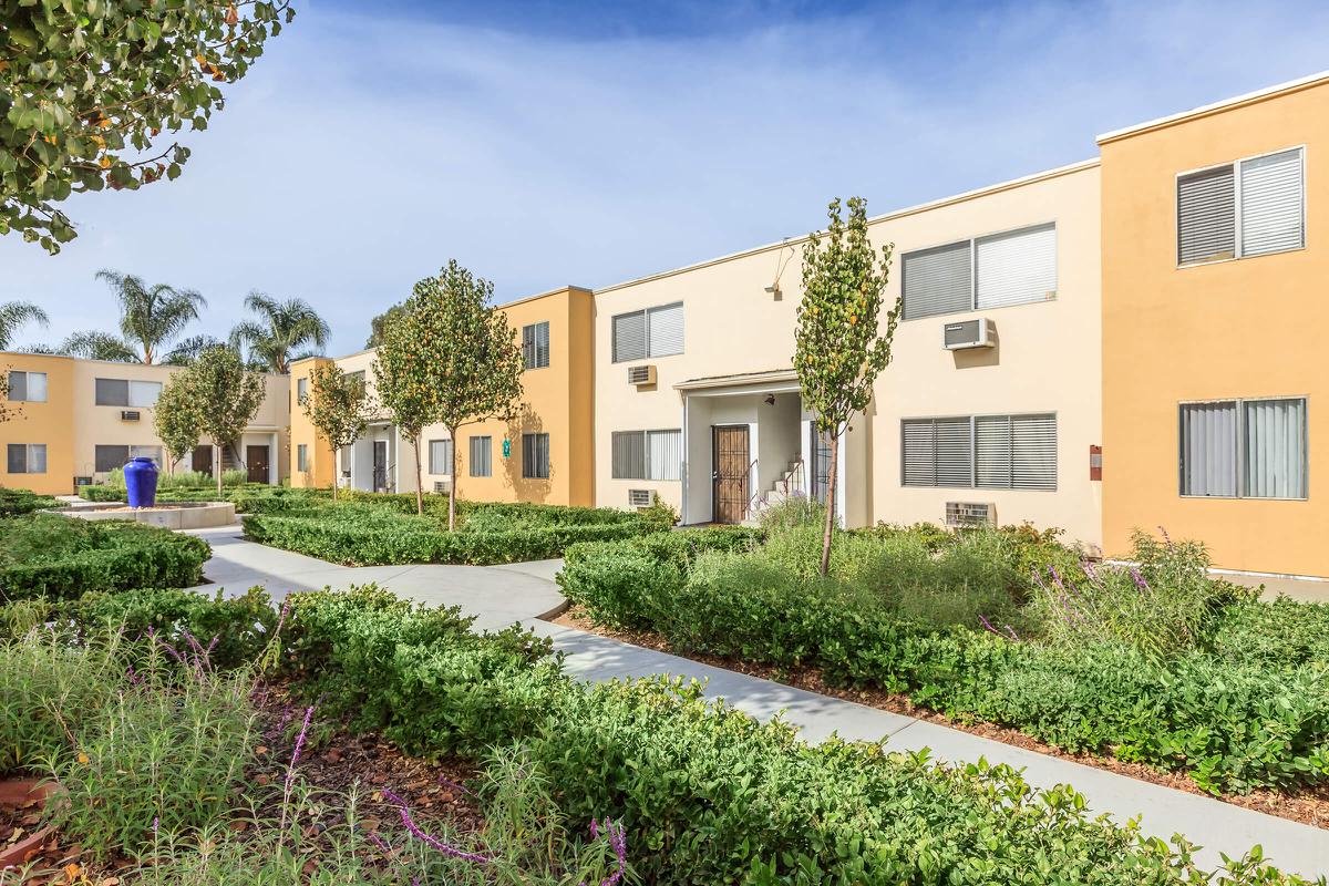 a house with bushes in front of a building