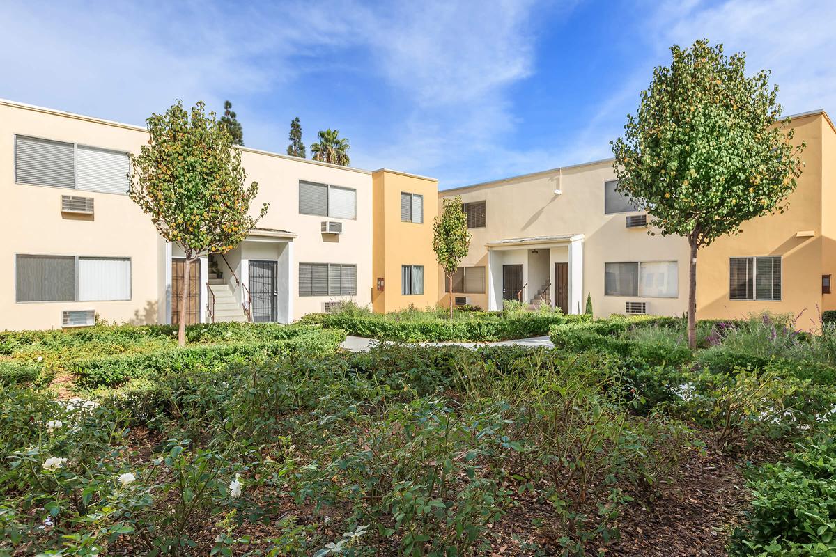 a house with bushes in front of a building