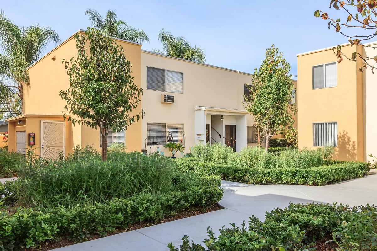 a house with bushes in front of a building