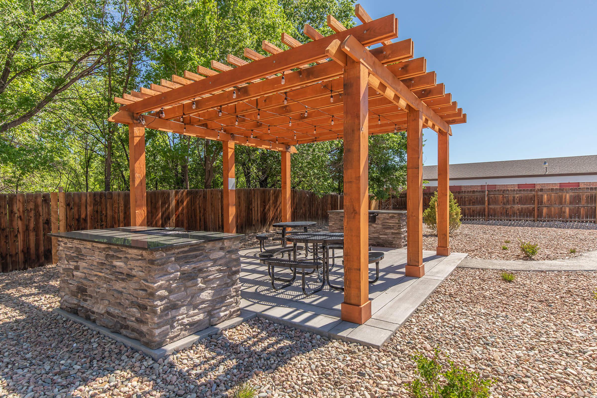 THE MONROE GRILLING STATION WITH WOODEN CANOPY AND SEATING AREA