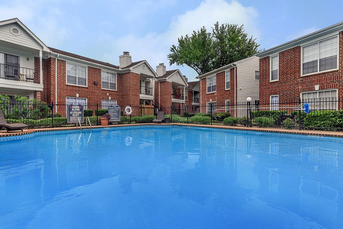 a house with a pool in front of a building