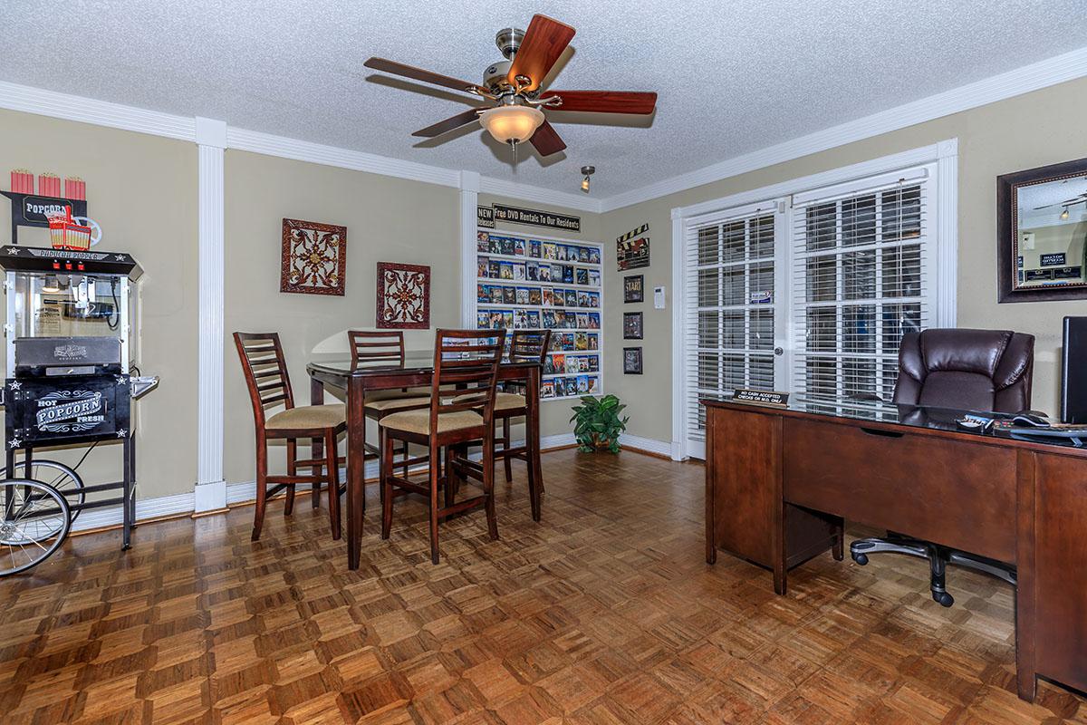 a living room filled with furniture and a large window