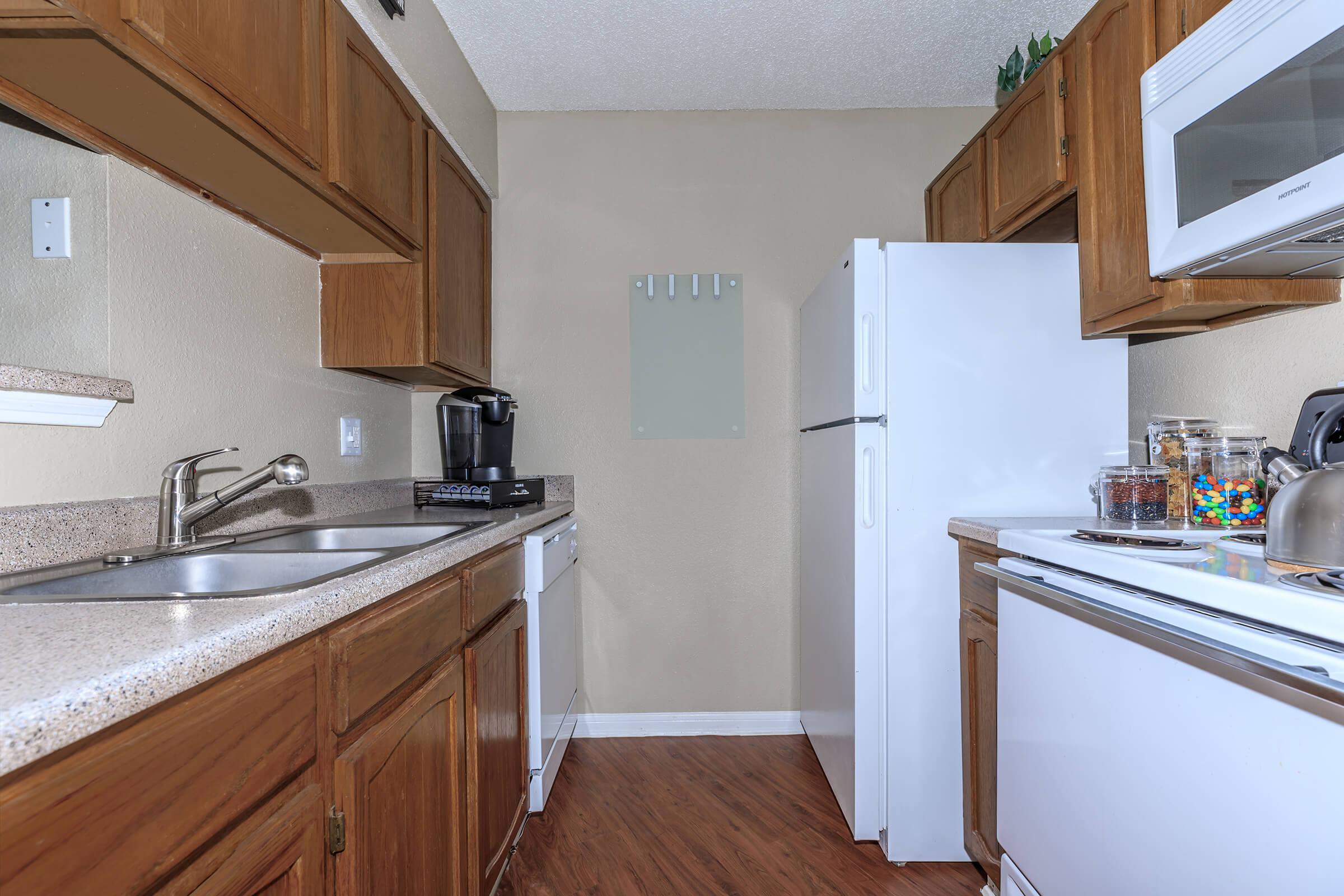 a kitchen with a stove sink and refrigerator