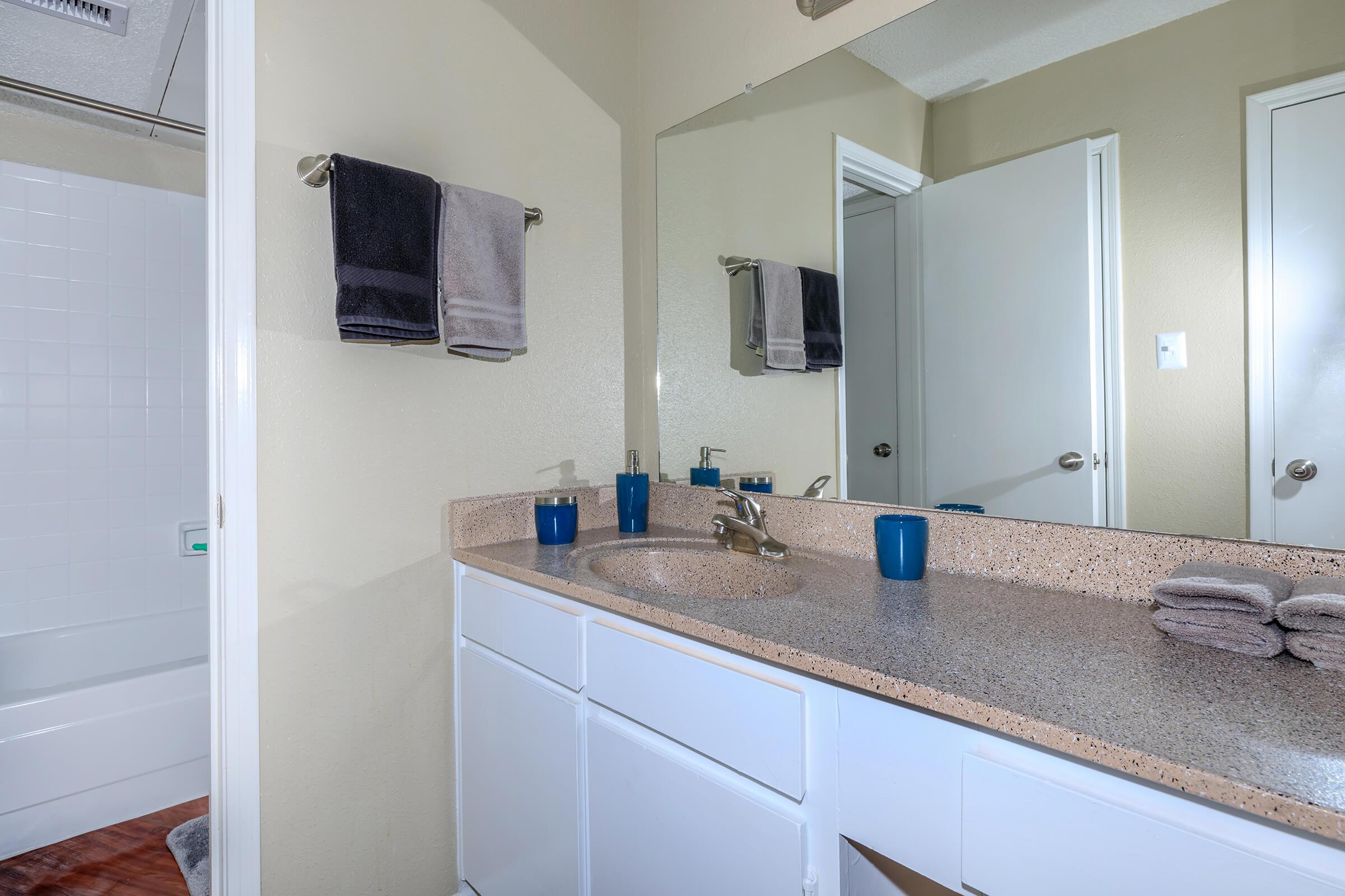 a kitchen with a sink and a mirror