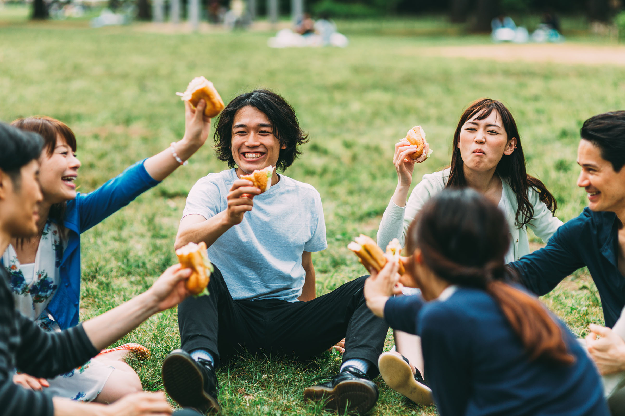 a group of people playing frisbee in a park