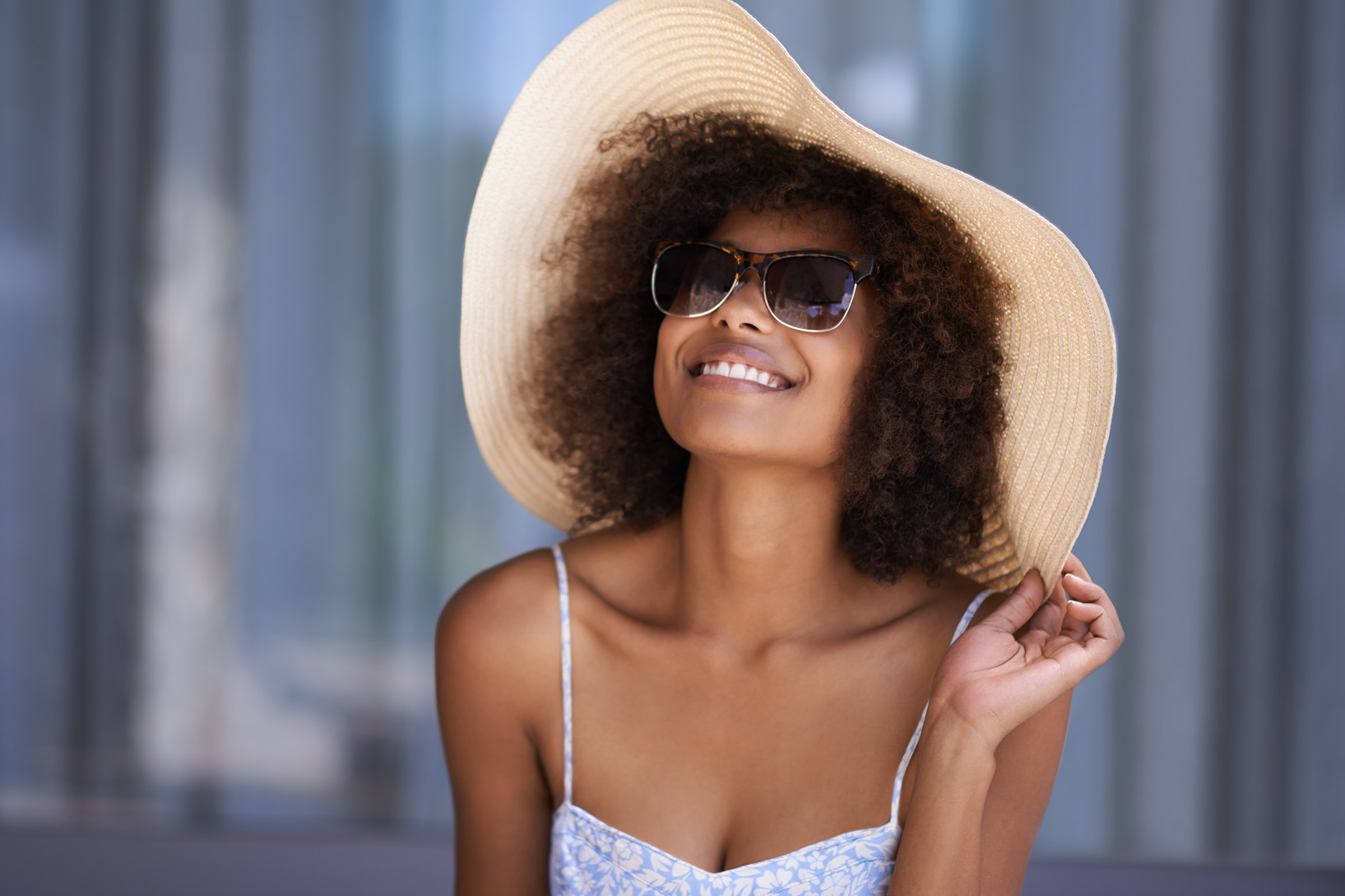 a person wearing a hat and sunglasses