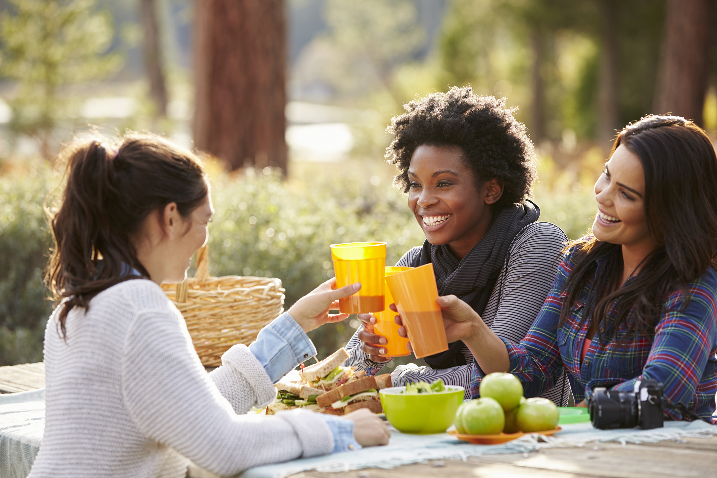 a woman sitting at a table with food