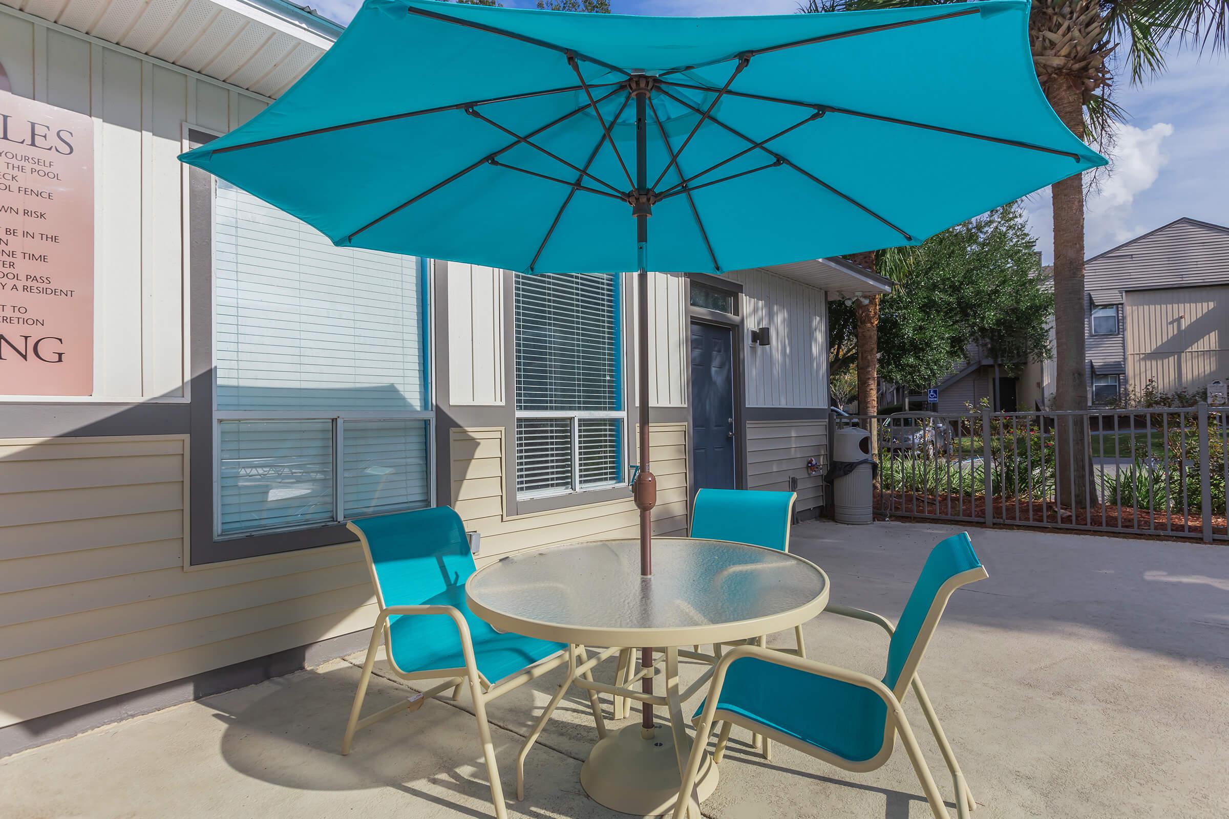 a table topped with a blue umbrella