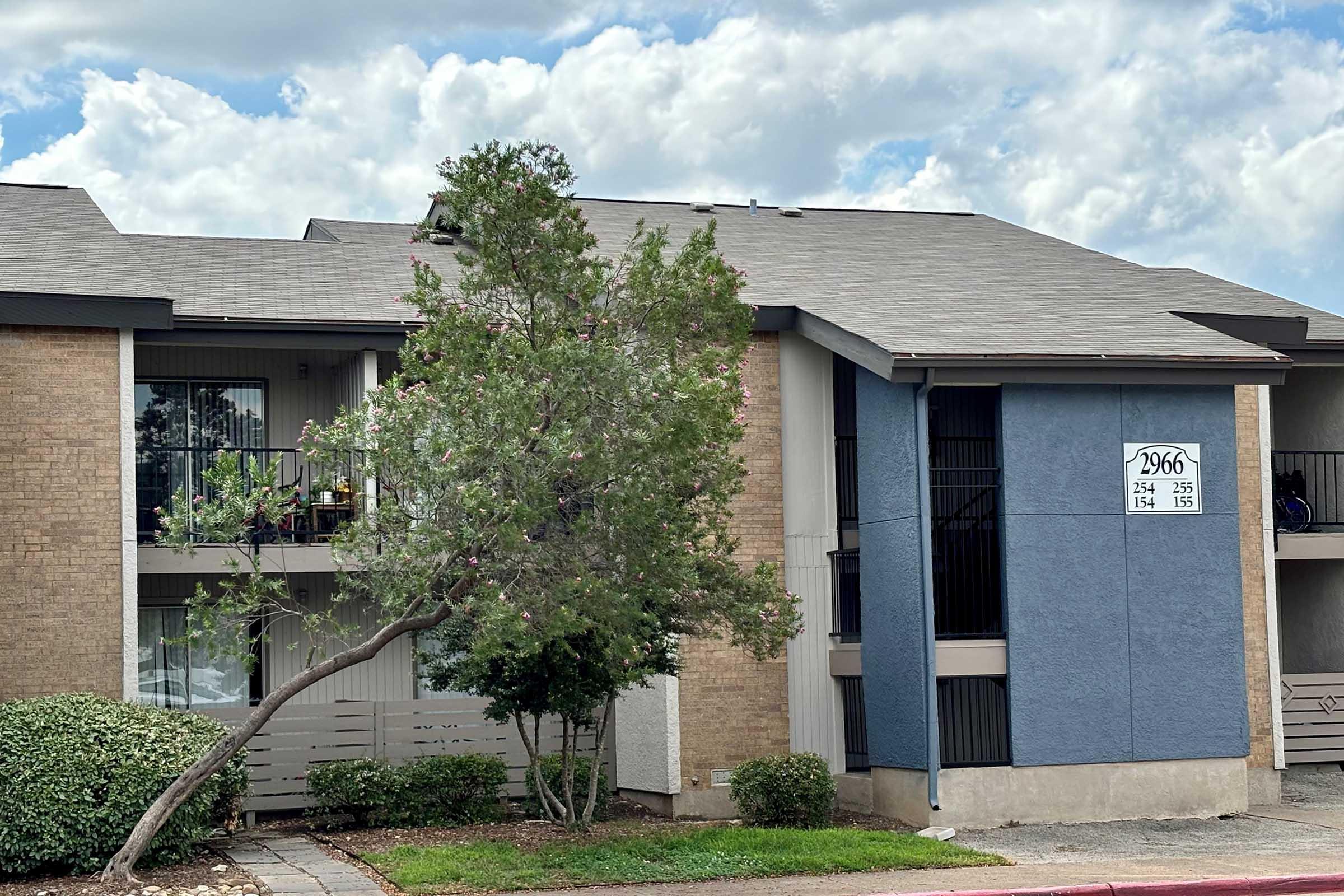 a house in front of a brick building