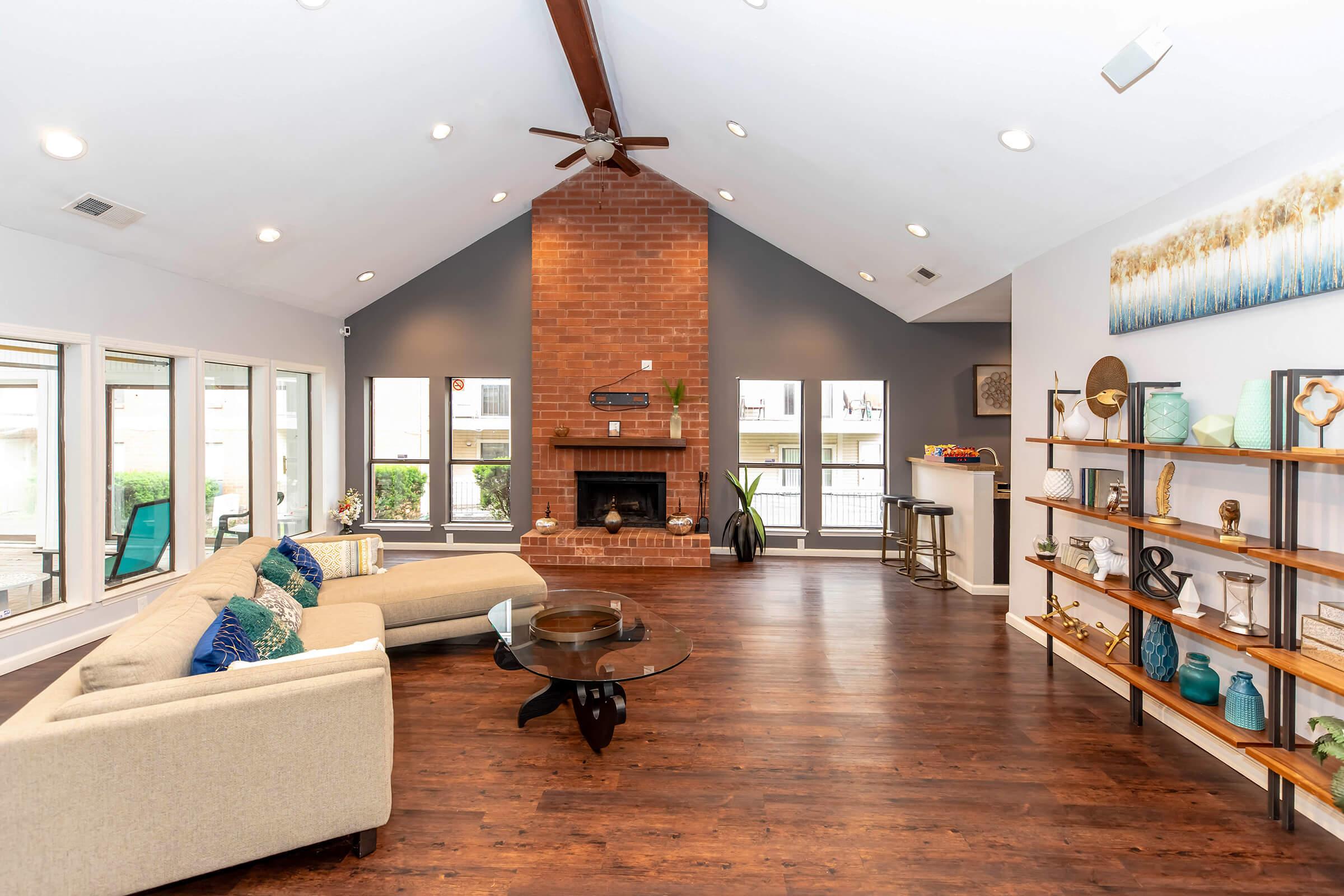 a living room filled with furniture and a large window