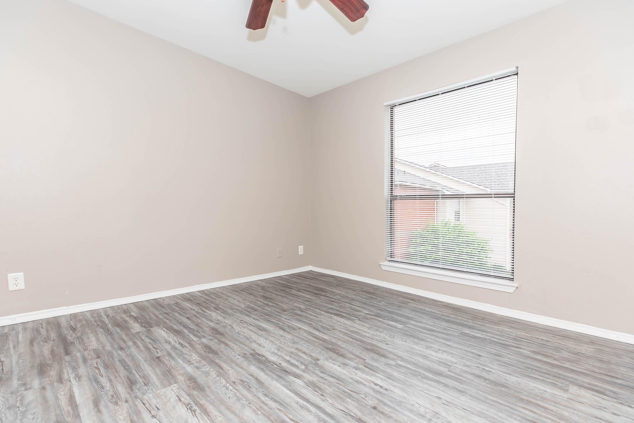 a bedroom with a wooden floor