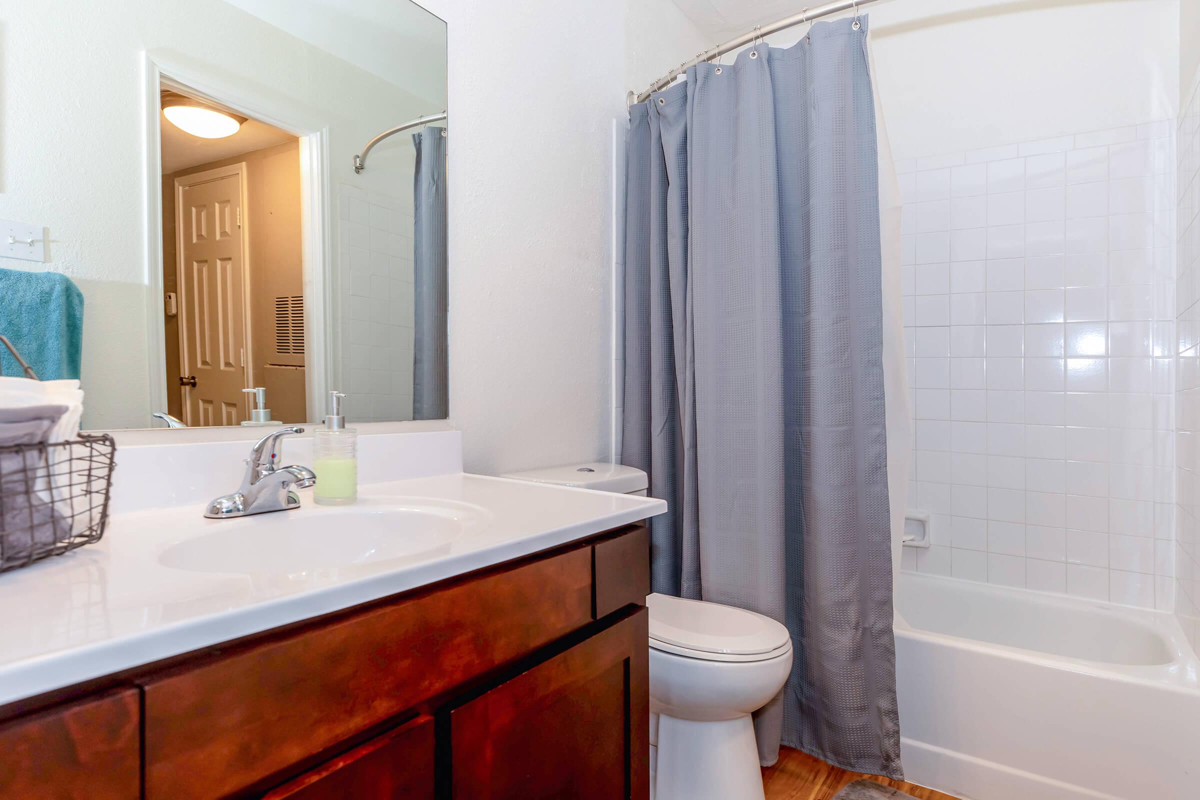 a sink and a white tub sitting next to a shower