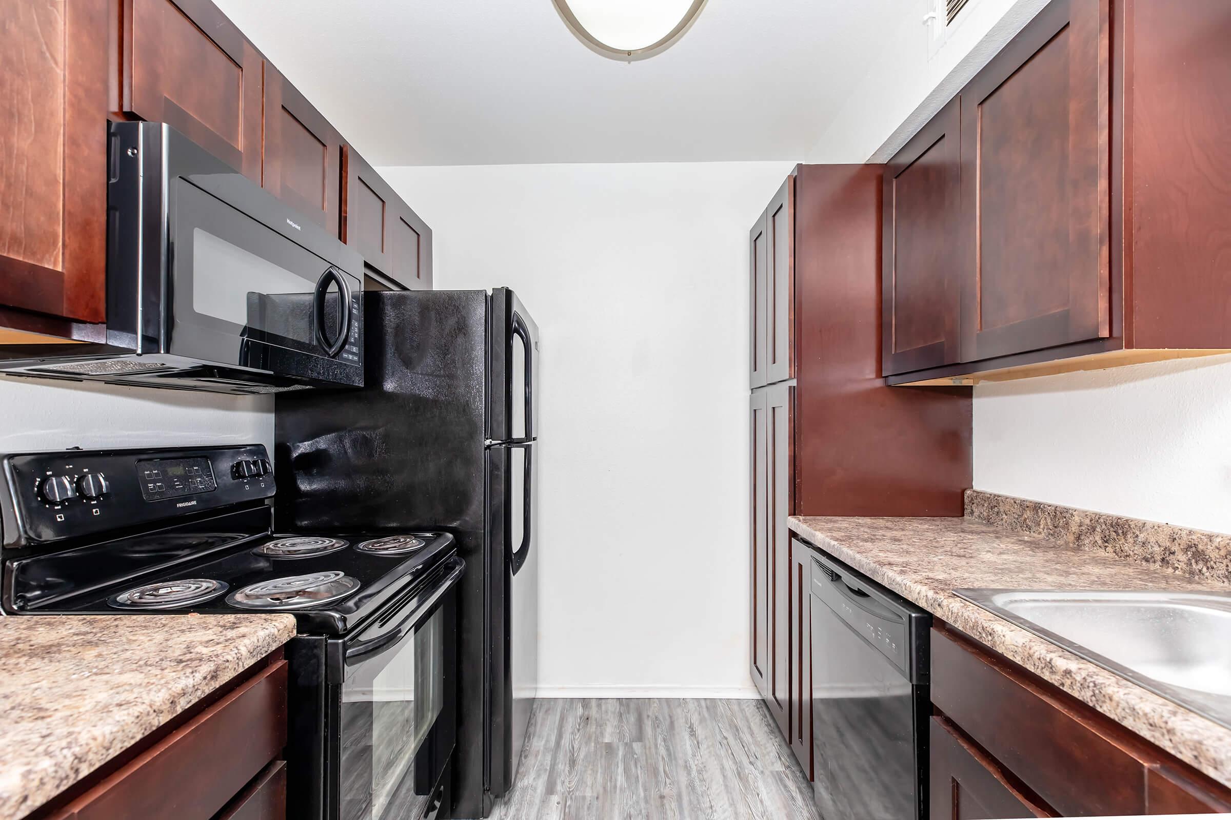 a modern kitchen with stainless steel appliances and wooden cabinets