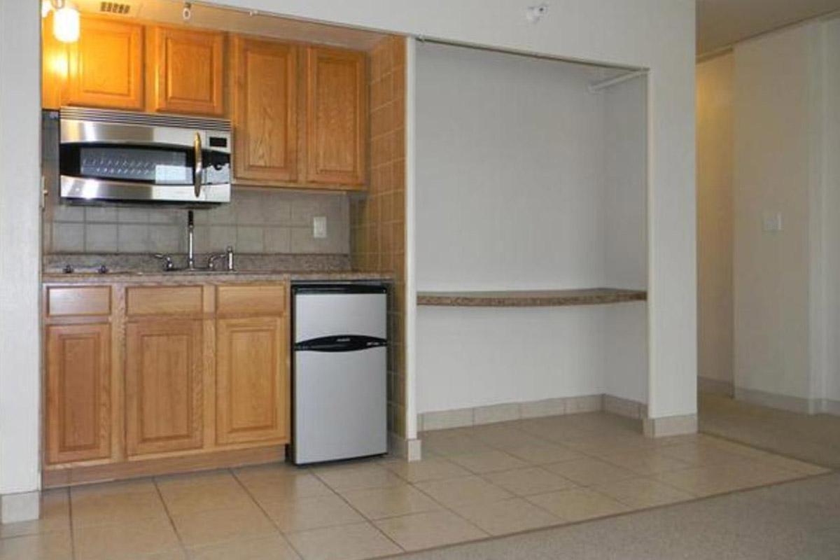 a kitchen with stainless steel appliances and wooden cabinets