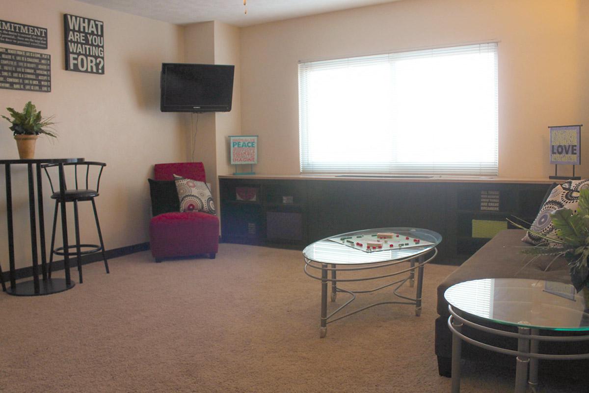 a living room filled with furniture and a window