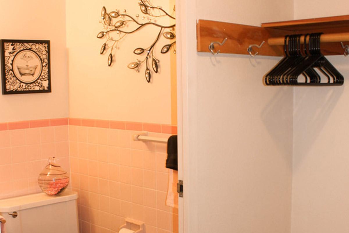 a white sink sitting under a mirror