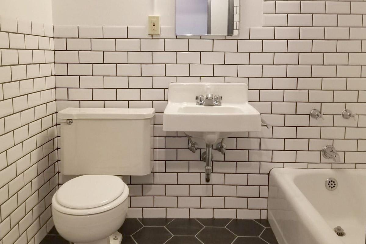 a small white sink in a public restroom