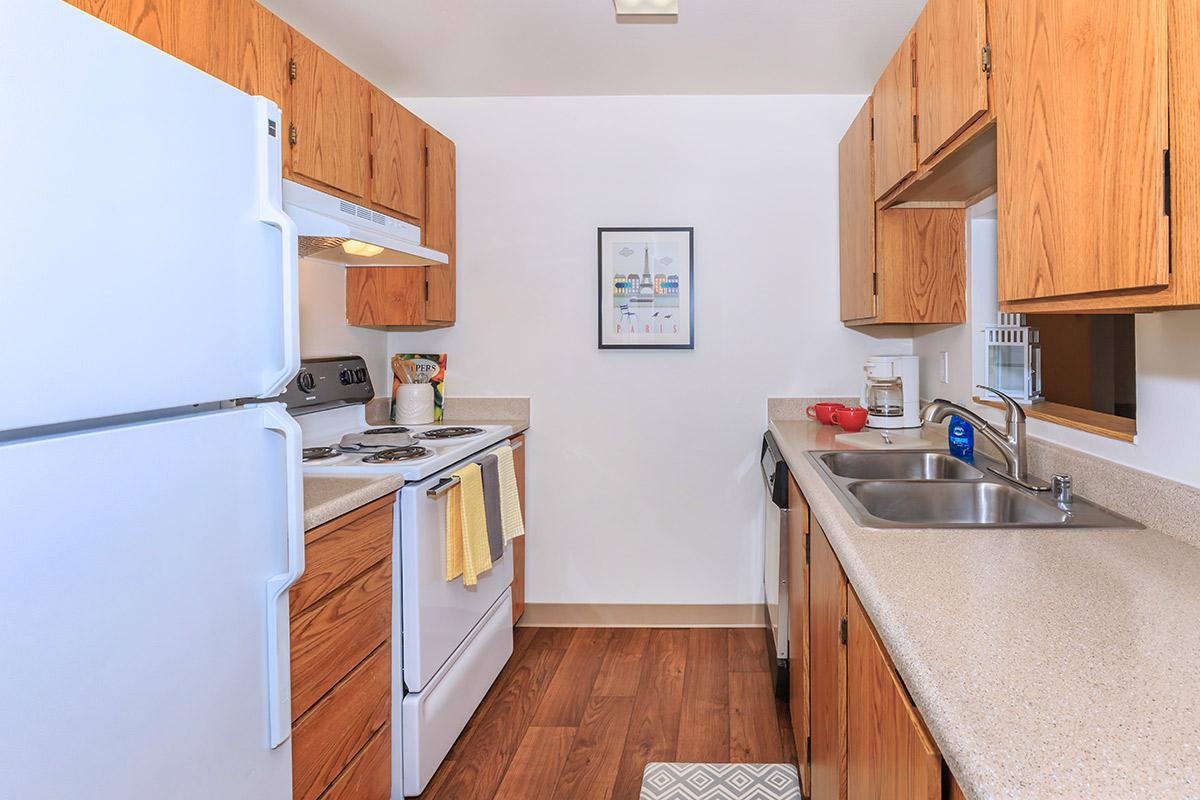 a kitchen with stainless steel appliances and wooden cabinets