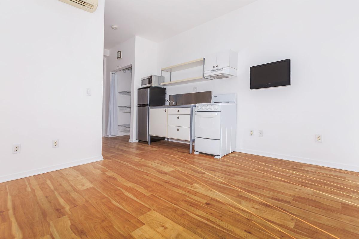 a large empty room with a wood floor