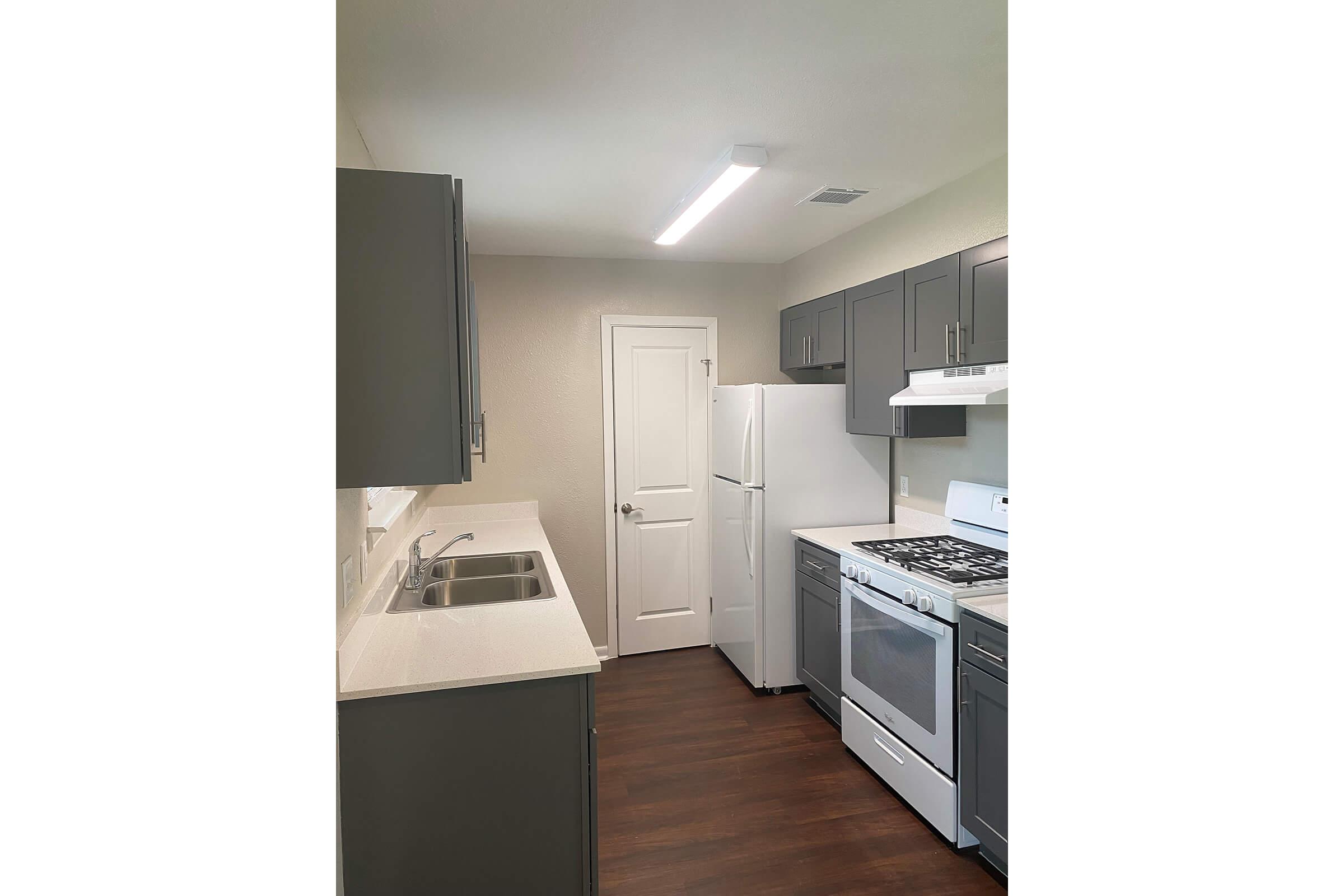 a kitchen with a stove and a refrigerator