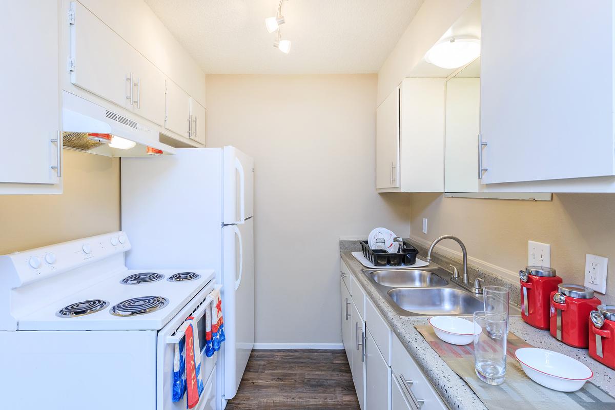 a kitchen with a stove sink and refrigerator