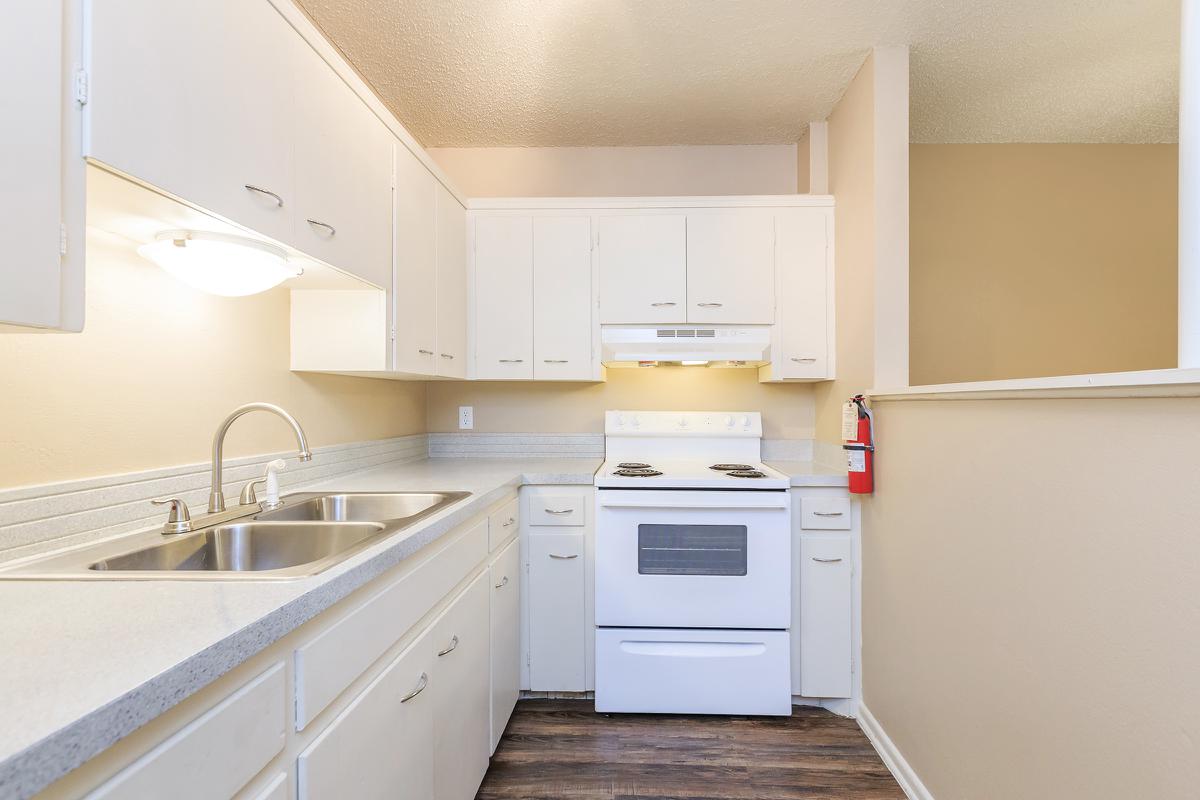 a kitchen with a white stove top oven