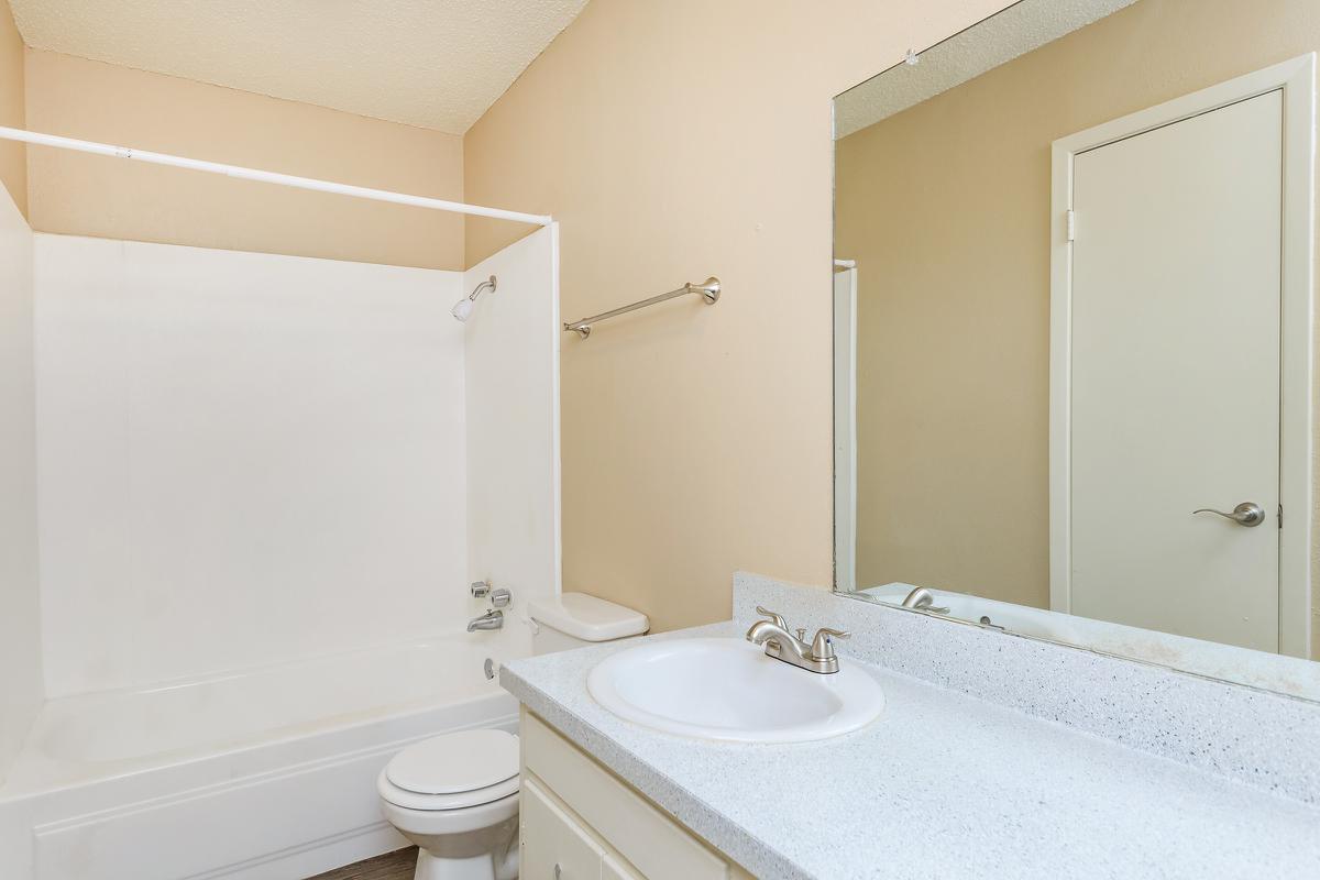 a white tub sitting next to a sink