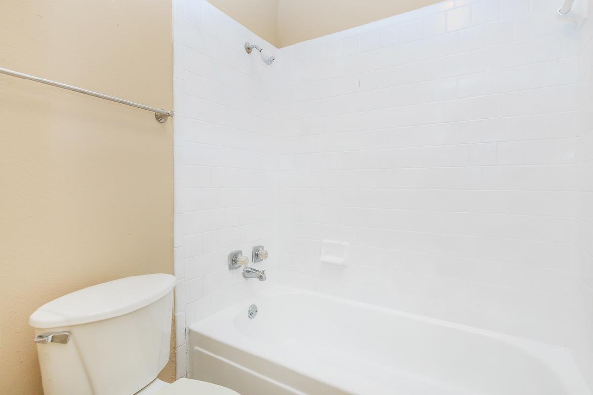 a white tub sitting next to a shower