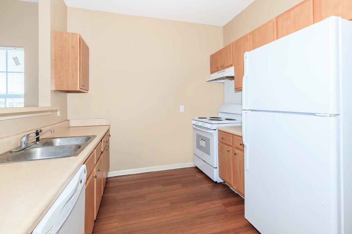 a kitchen with a stove sink and refrigerator