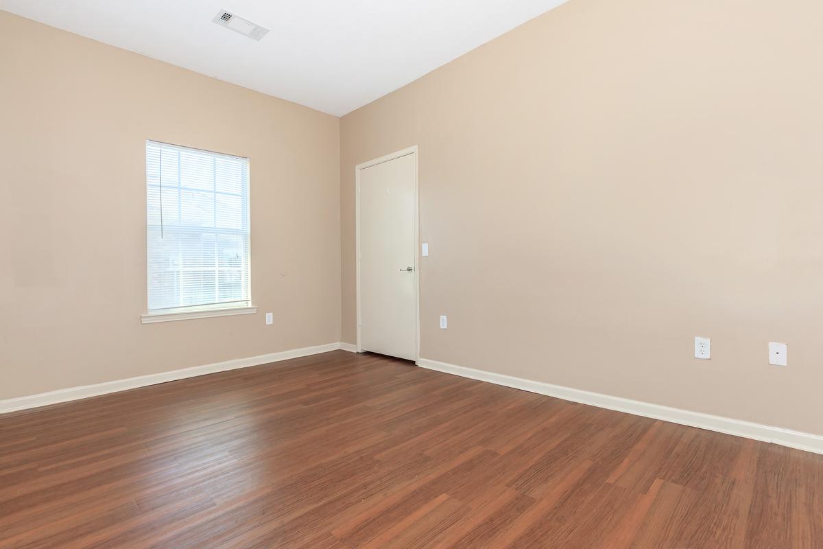 a large empty room with a wood floor