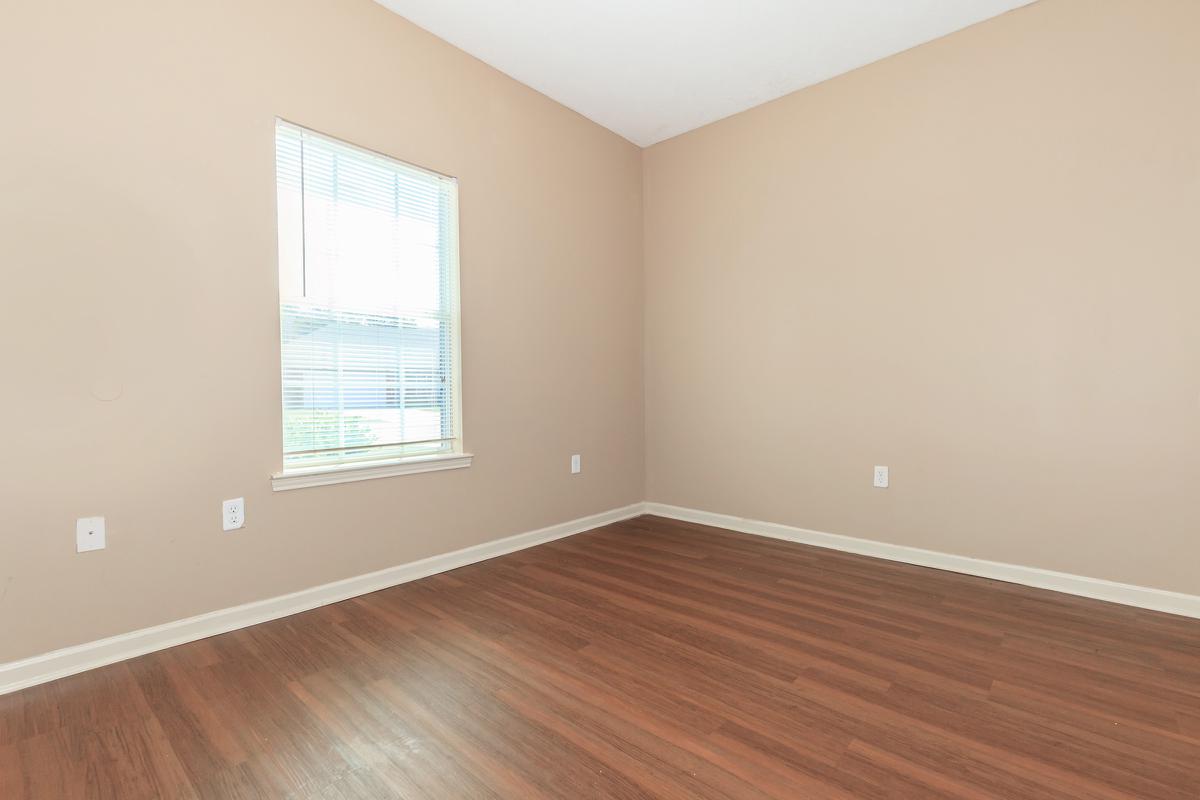 a close up of a hard wood floor next to a window