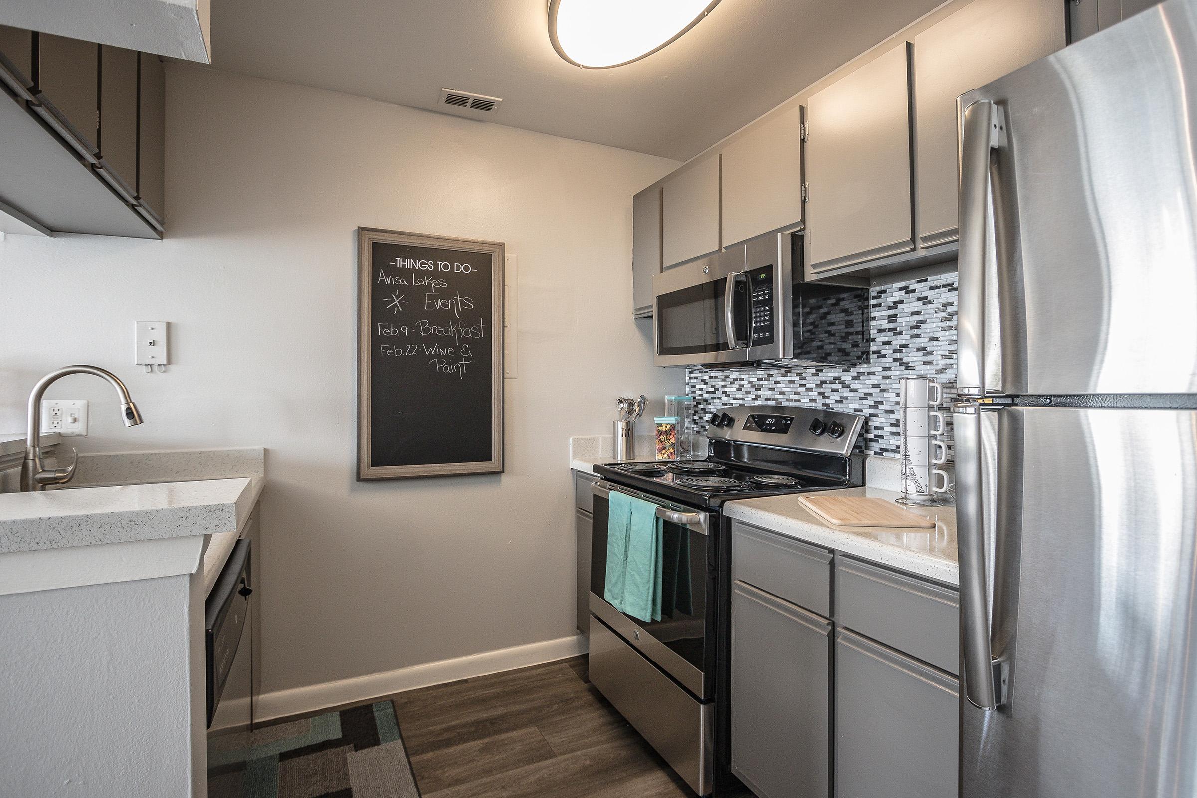 a kitchen with a sink and a refrigerator