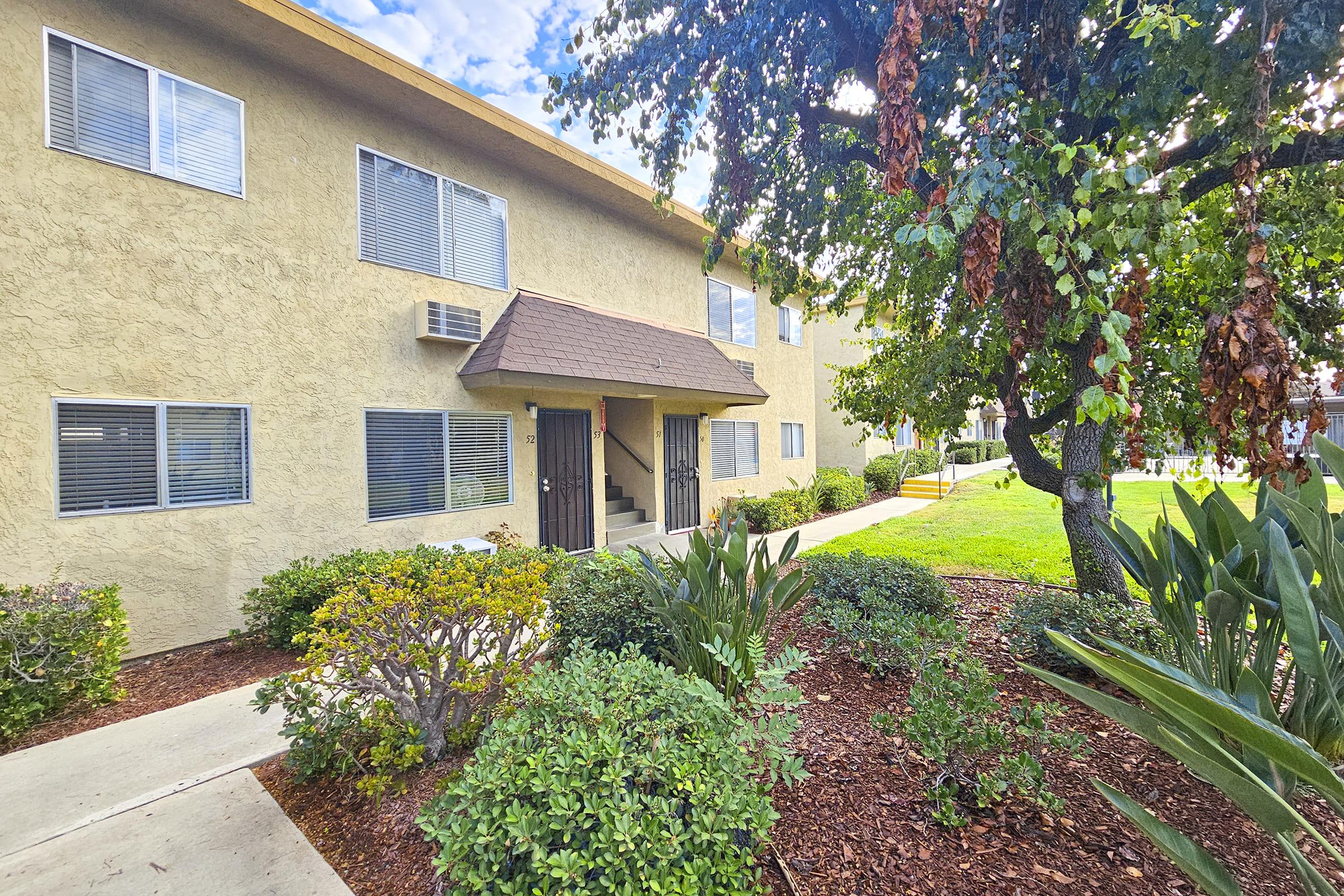 a house with bushes in front of a building