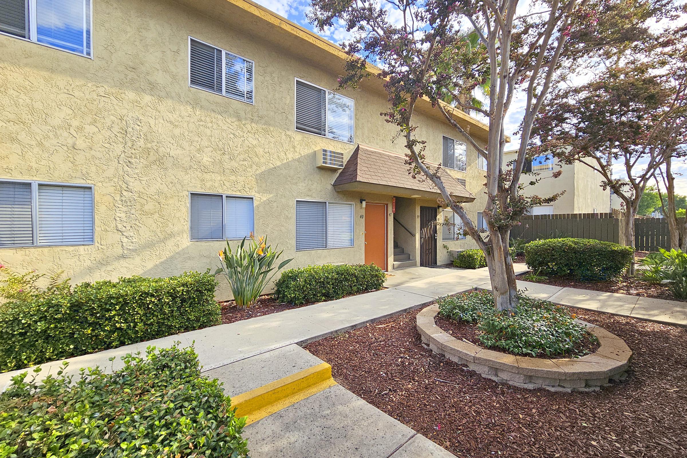 a house with bushes in front of a building