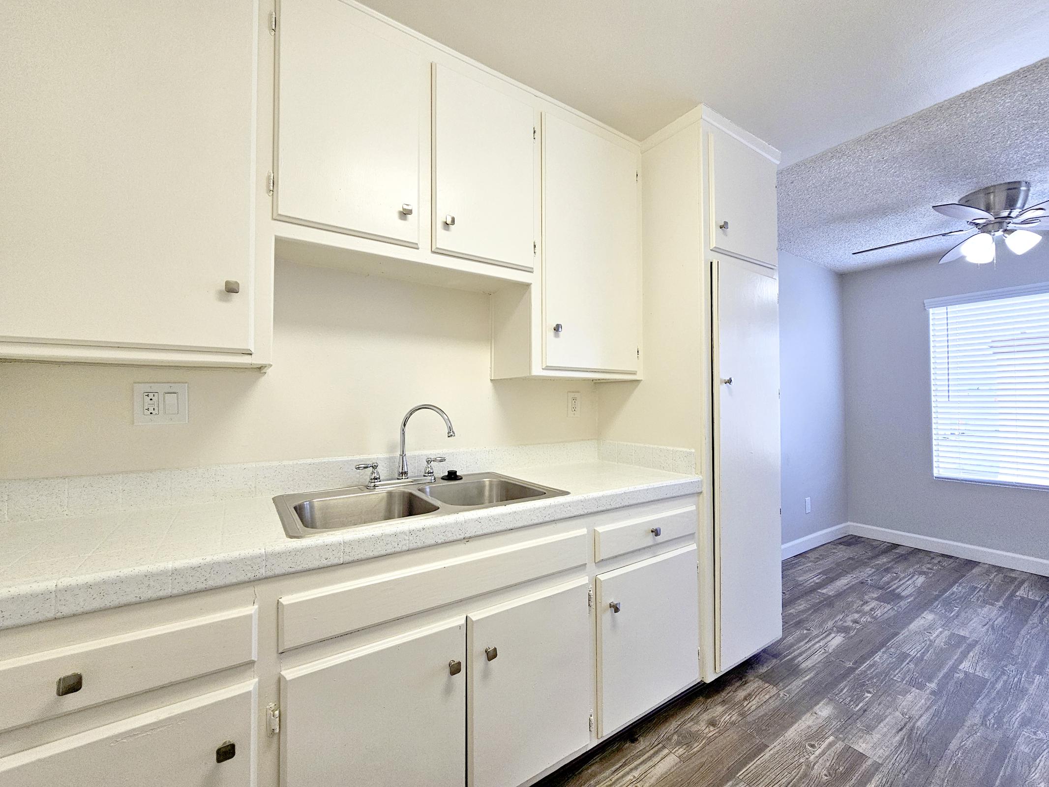 a kitchen with a sink and a mirror