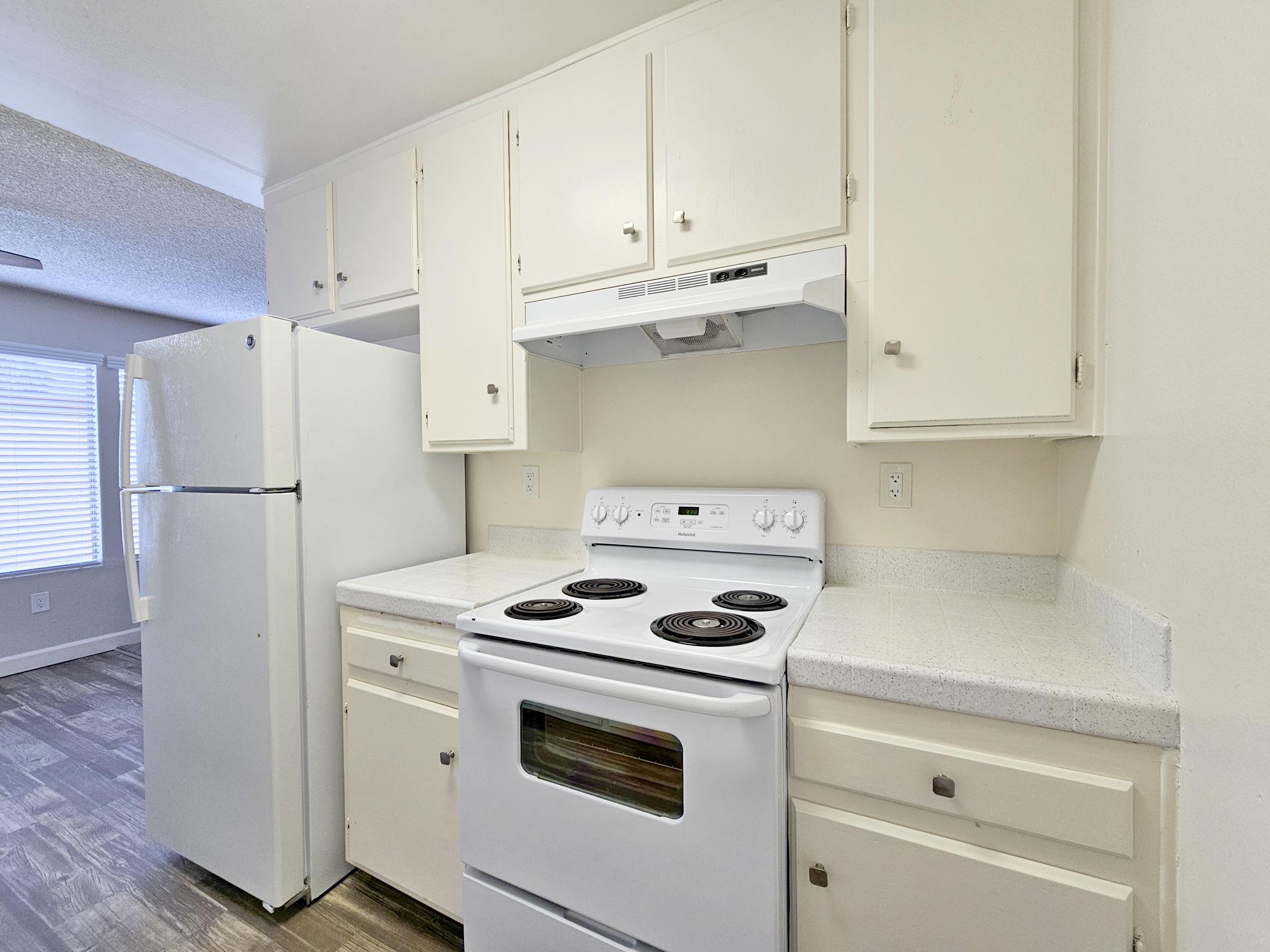 a stove top oven sitting inside of a kitchen