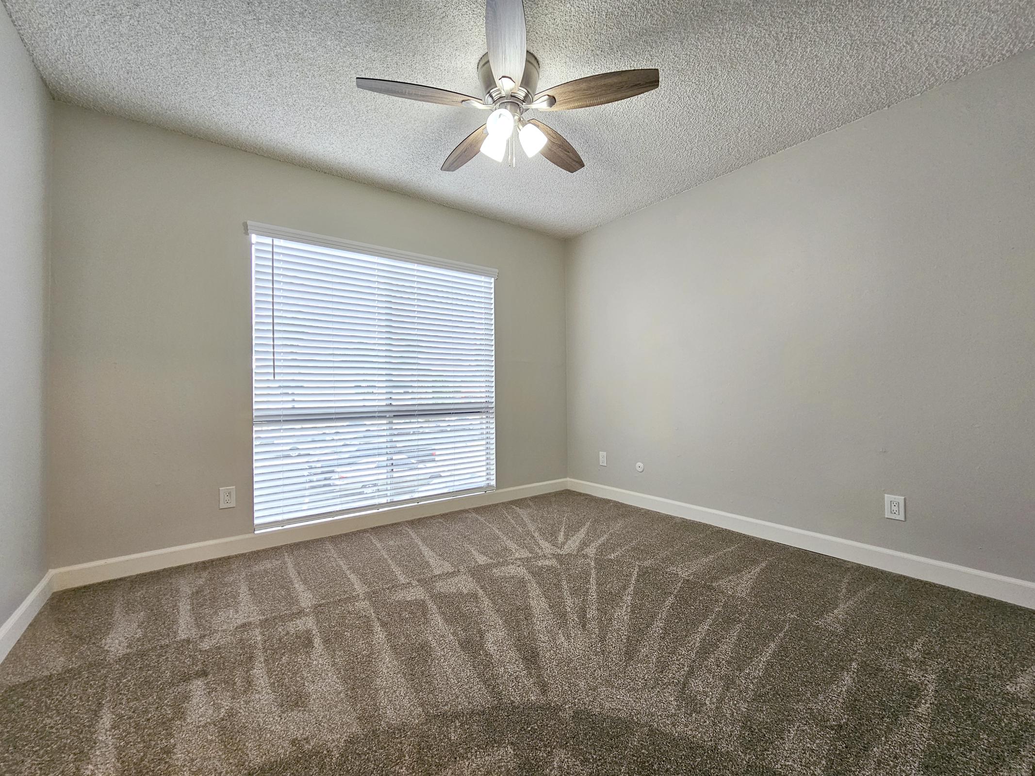 a bedroom with a large window