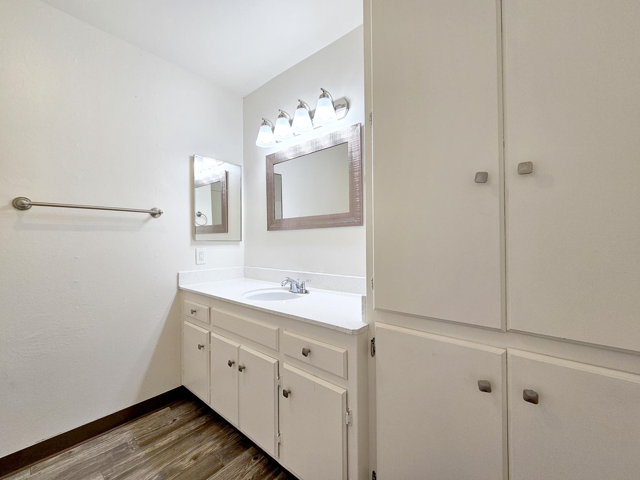 a kitchen with a sink and a mirror