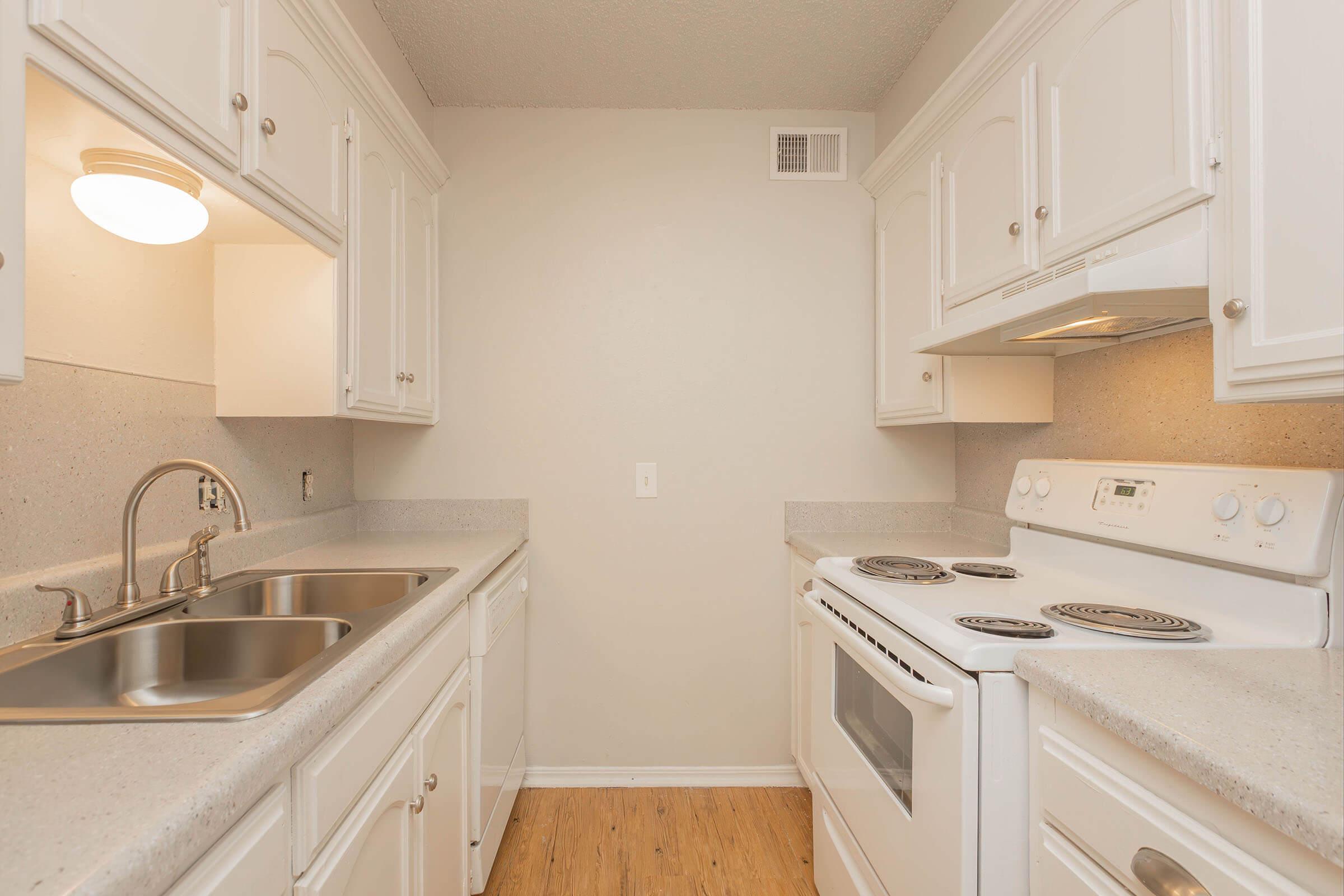 a kitchen with a stove and a sink