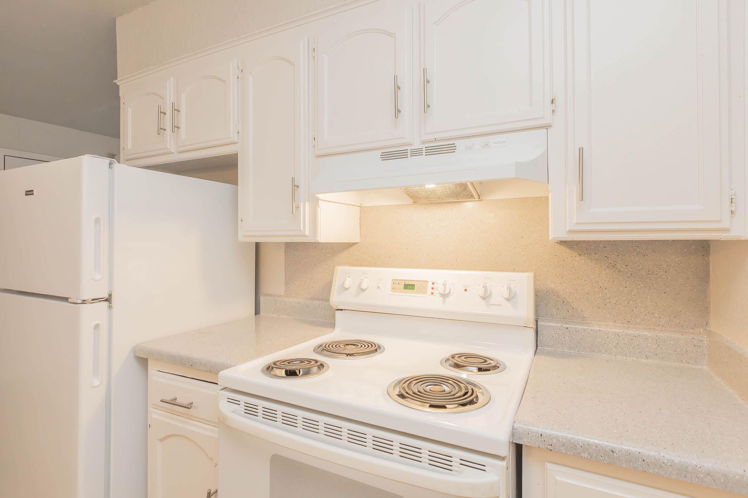 a kitchen with a stove top oven sitting inside of a refrigerator