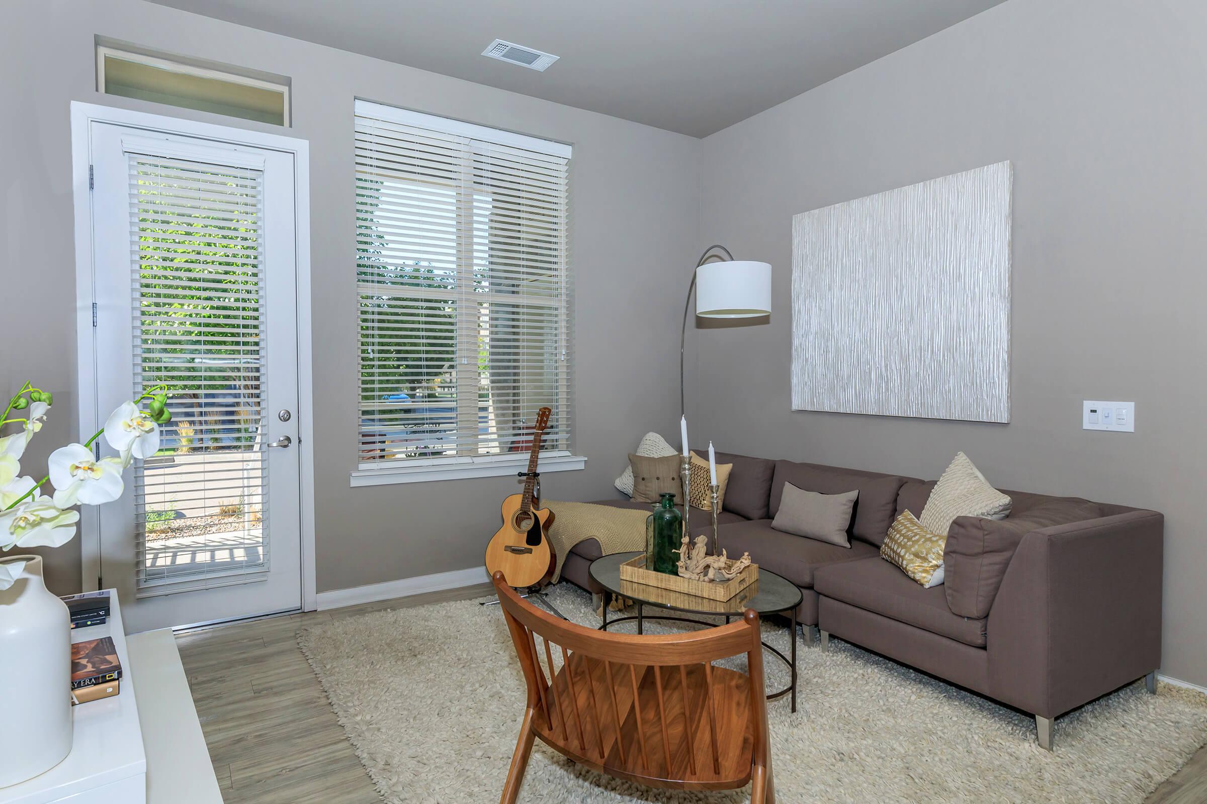 a living room filled with furniture and a large window