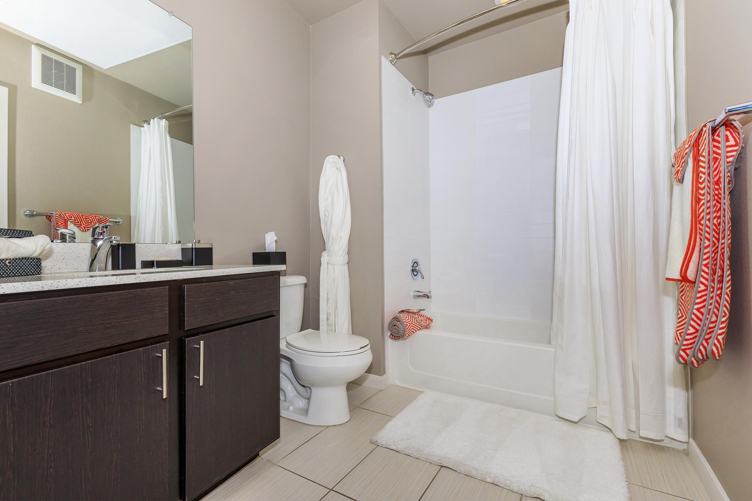 a white tub sitting next to a shower