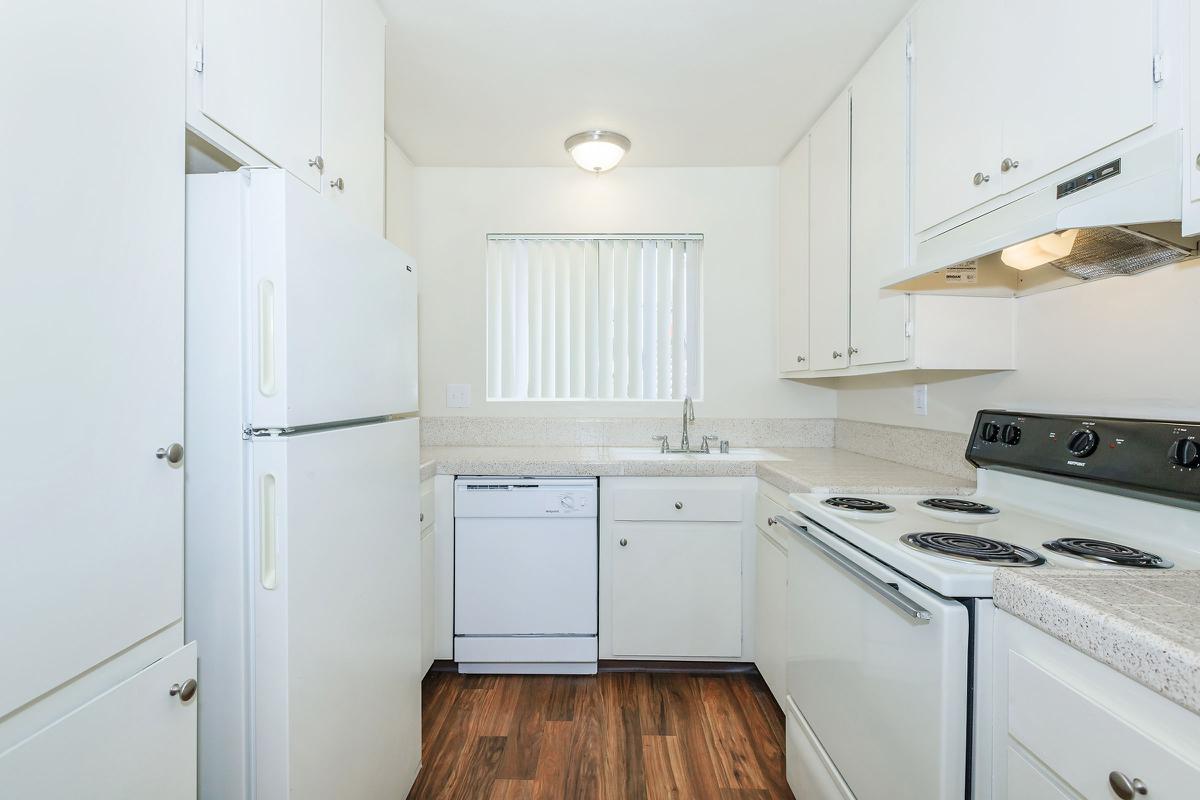 a kitchen with a stove and a refrigerator