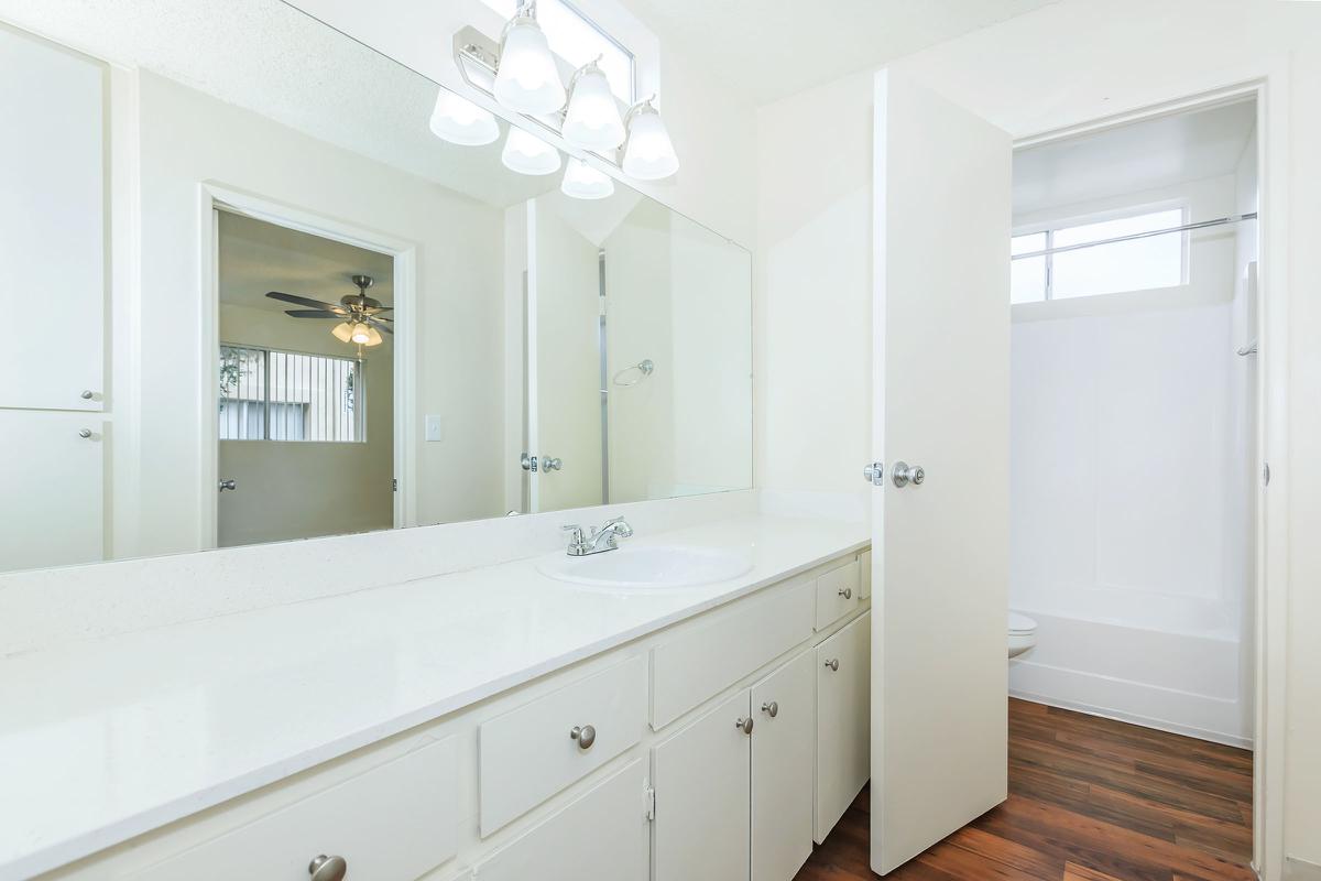 a kitchen with a sink and a mirror